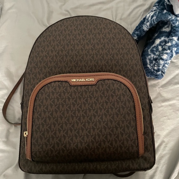 Buy the Michael Kors Monogram Backpack Brown